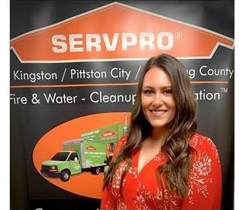 Female SERVPRO rep in front of SERVPRO sign