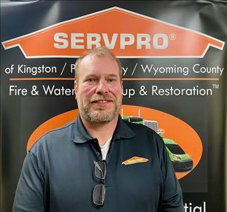 Male SERVPRO technician in front of pop up sign 