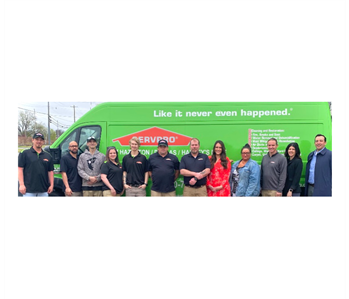 SERVPRO employees in front of green van 