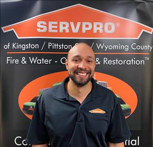 Male SERVPRO technician in front of pop up sign 