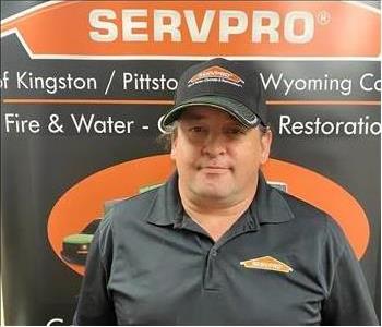 Male SERVPRO technician in front of pop up sign