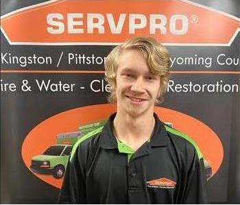 Male SERVPRO technician in front of pop up sign 