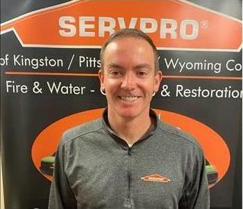 Male SERVPRO technician in front of pop up sign 