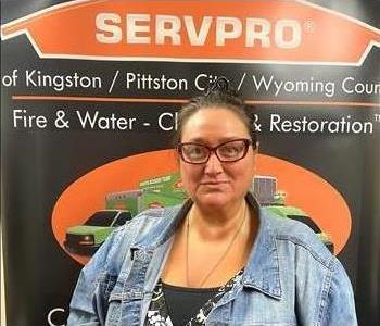 Female SERVPRO rep in front of SERVPRO sign