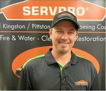 Male SERVPRO technician in front of pop up sign 