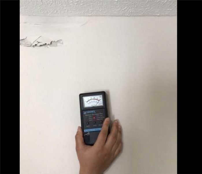 moisture meter on white wall