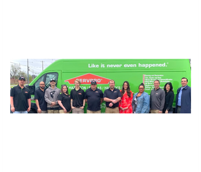 SERVPRO employees in front of green van