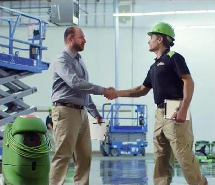 SERVPRO technician with commercial property owner